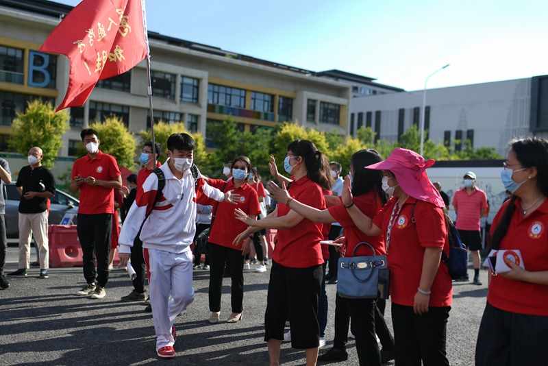 6月7日，在北京市人大附中通州校區(qū)考點(diǎn)，考生與送考老師擊掌加油。人民網(wǎng)記者 翁奇羽攝