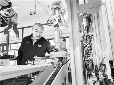 郭海青在檢查車床加工設(shè)備。 受訪者供圖
