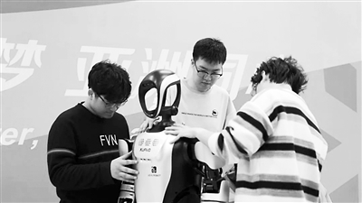 哈爾濱工業(yè)大學(xué)的學(xué)生正現(xiàn)場調(diào)試機(jī)器人。受訪單位供圖