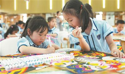 圖為小朋友在制作紙鳶。本報記者 何亮攝